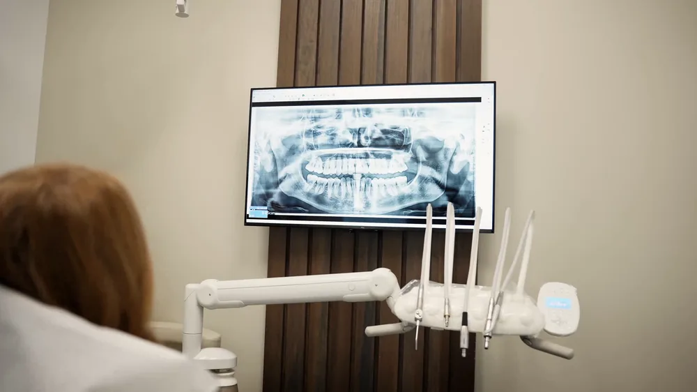 A treatment room at Brightside Dental in West Kelowna, with a panoramic x-ray on the wall-mounted screen